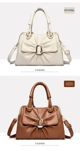 Detailed comparison of off-white and tan leather handbags with metal buckles and pleats