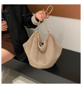 Close-up of plush khaki tote bag with leather trim and sleek shoulder straps for autumn