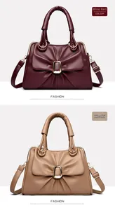 Detail view of burgundy and khaki leather handbags with bow design and gold hardware