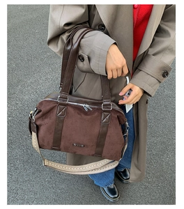 Detail of dark brown suede Boston bag with ethnic woven strap and dual handles