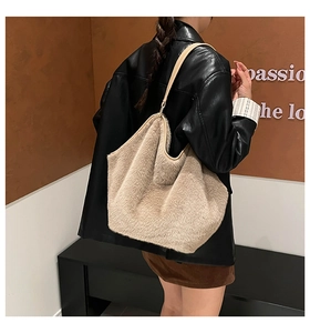 Detail of plush faux fur shoulder bag with leather strap and metal ring attachment