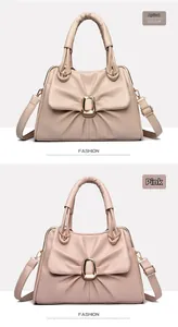 Detail view of large capacity crossbody bags with pleated design and gold metal buckle