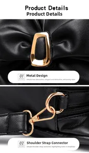 Detail view of golden bow hardware and detachable strap clasp on a black leather bag