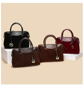 Detail of four retro Boston bags in black, brown, and burgundy with metal F pendant