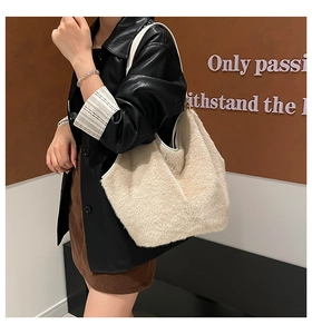 Detail of soft cream faux fur tote bag showing the plush texture and hobo design style