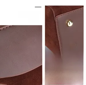 Detail of vintage Boston bag showing gold logo and protective metal feet studs
