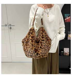 Detail view of large leopard print faux fur tote bag with brown straps for autumn fashion