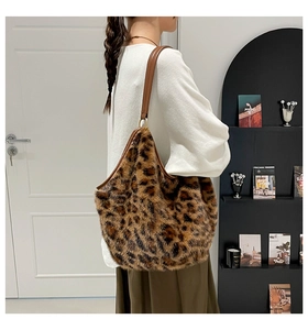 Detailed close-up of leopard print faux fur tote bag with brown leather shoulder strap