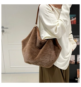 Close-up of brown leopard faux fur tote bag with premium leather handles and trim