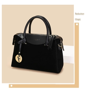 Close-up of black suede and leather Boston bag featuring gold F-letter charm and zipper