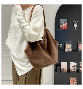Detail showing plush faux fur texture and leather strap of the brown tote bag