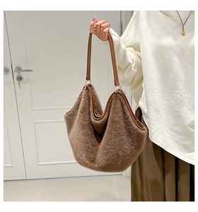 Detail of soft leopard print plush tote bag featuring a premium brown leather shoulder strap