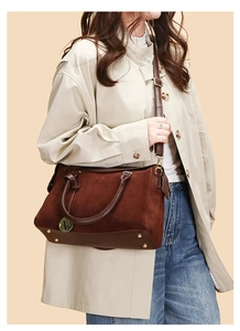 Detailed close-up of dark brown Boston bag with golden F charm and soft suede texture