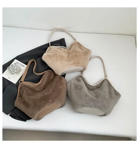 Three plush leopard print tote bags in beige, brown and grey on a decorative tabletop