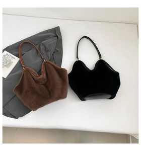 Detail view of stylish faux fur tote bags with wave-shaped rims and golden hardware