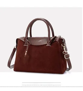 Detail showing high-quality leather and suede patchwork texture of the Boston handbag