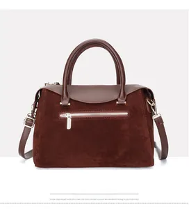 Detail of vintage suede and leather Boston bag with metallic zipper and gold hardware
