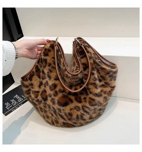 Detailed close-up of leopard print faux fur tote bag with brown faux leather handles