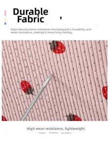 Detail of durable pink corduroy fabric with strawberry print showing wear-resistance
