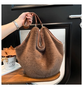 Detailed close-up of leopard print faux fur tote bag with brown leather handles and strap