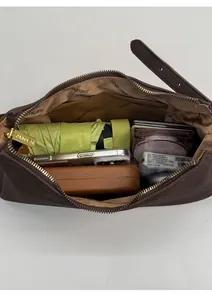 Deep brown textured shoulder bag showing large interior capacity with daily essentials