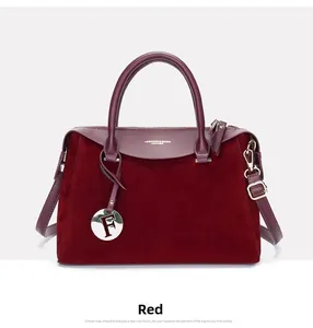 Close-up of burgundy Boston bag with suede panels and gold-tone F-letter charm