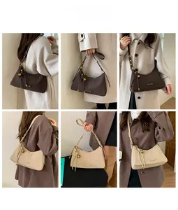Detail view of retro half-moon underarm bags with adjustable straps in two versatile colors