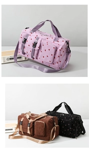 Detail of strawberry print corduroy travel bag with functional pockets and shoulder strap