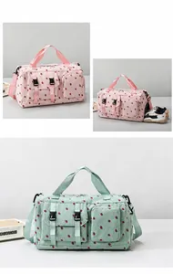 Detail of travel bag with side shoe compartment and red strawberry pattern prints