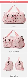 Detail view of pink corduroy travel bag with strawberry print and multiple functional pockets