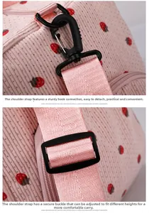 Detail of pink corduroy travel bag showing detachable swivel hook and adjustable strap