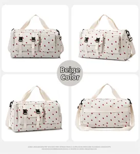 Detail view of large beige travel bag with strawberry print and multiple pockets