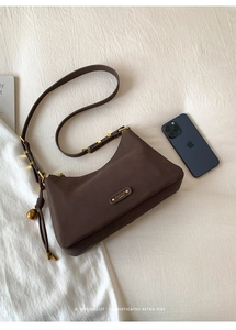 Detailed macro view of the vintage brown suede texture with gold metal buckle and tassel