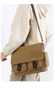 Detail view of khaki canvas messenger bag with large flap and front utility pockets