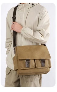 Side view of khaki canvas messenger bag with double buckles and utility pockets