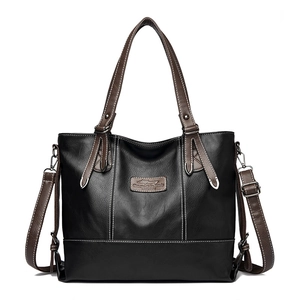 Classic black leather tote bag with brown handles and white contrast stitching detail