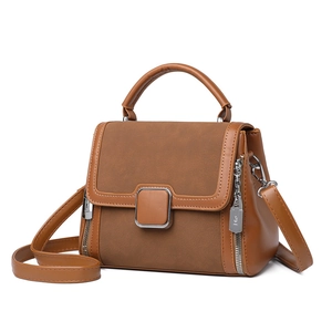 Minimalist brown patchwork leather handbag with top handle and adjustable shoulder strap