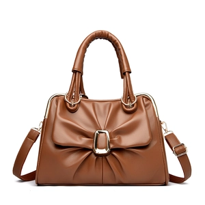 Caramel brown handbag with bow-tie pleats, golden metal buckle and crossbody strap