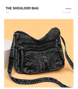Dettaglio della borsa a tracolla grande in denim nero con tasche multiple a cerniera
