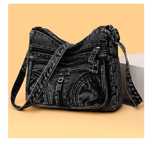Dettaglio borsa a tracolla in denim grigio scuro lavato con tasche multiple a zip