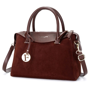 Retro deep brown Boston handbag with leather splicing and gold hardware on white background
