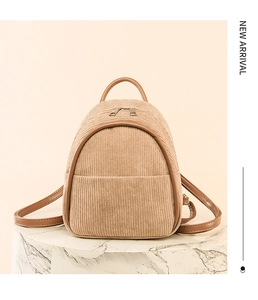 Close-up of texture on khaki corduroy mini backpack with brown faux leather trim