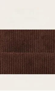 Detail of brown corduroy fabric showing fine vertical texture and soft matte finish
