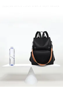 Detailed view of black pebbled PU leather backpack showing its lightweight 0.5kg design