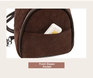 Detail view of corduroy bag front pocket with neat stitching and storage box inside