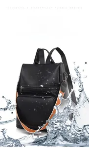 Waterproof detail of black lychee texture PU leather backpack with orange strap accents