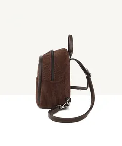 Side view of brown corduroy backpack showing zipper closure and strap hardware details
