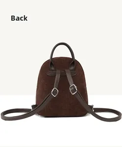 Back view of brown corduroy mini backpack with dark brown leather straps and metal buckles