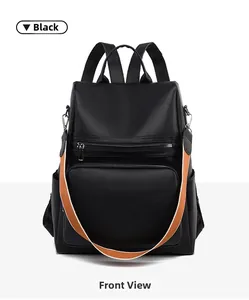 Front view of black PU leather backpack with contrasting orange shoulder strap detail