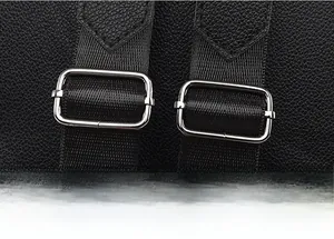 Detail of adjustable high-density nylon shoulder straps with silver metal buckles on a PU bag
